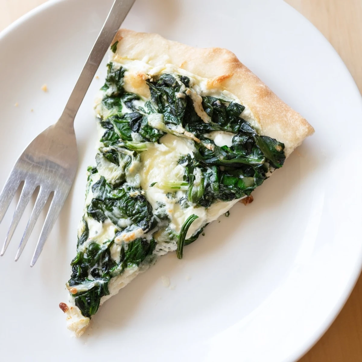 Freshly baked Spinach Ricotta Pizza on a wooden board, golden crust with creamy ricotta and sautéed spinach.