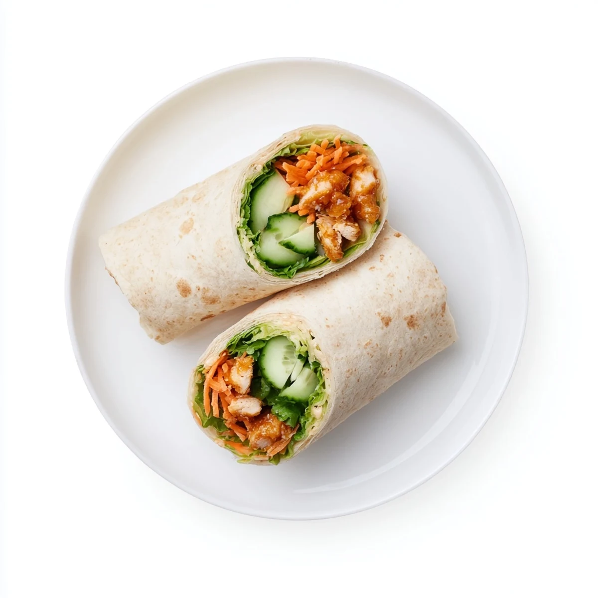 Freshly prepared Honey Chili Crunch Chicken Wrap cut on a diagonal, with visible scallions and drizzled honey chili sauce on a rustic wooden serving board.