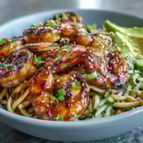 Close-up of a vibrant Grilled Shrimp Asian Noodle Bowl featuring smoky charred shrimp over sesame glistening noodles.