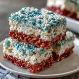 Chewy, colorful Rice Krispies squares with vibrant red, white, and blue layers, perfect for Independence Day parties.
