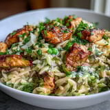 One-Pot Lemon Orzo with Chicken and Peas, a comforting spring dish featuring golden chicken, creamy orzo, and vibrant lemon zest.  