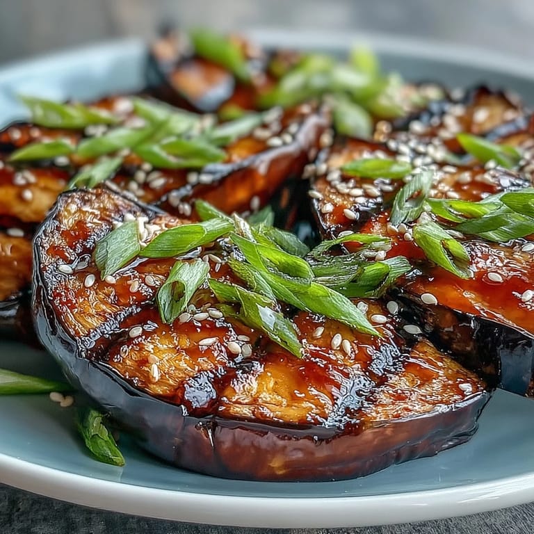 Tender, golden Miso Glazed Eggplant fresh from the broiler, showcasing its silky texture and rich umami aroma as a perfect Japanese side dish.